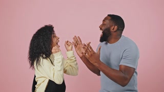 Hooray. Excited african american couple looking at each other and shouting, enjoying success and great promo